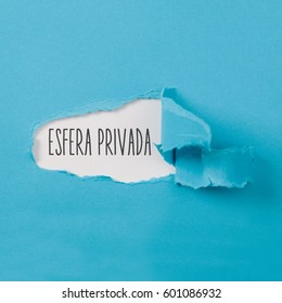 Esfera privada, Spanish text for Private Sphere, text on paper revealing secret behind torn blue carton ripped open - Shutterstock ID 601086932