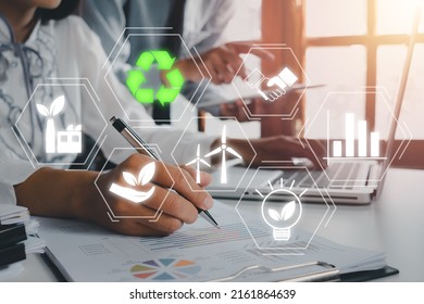 ESG concept of environmental, Green ethical business preserving resources, reducing CO2, Caring for employees, Business person team working on laptop computer with VR screen ESG icon. - Powered by Shutterstock