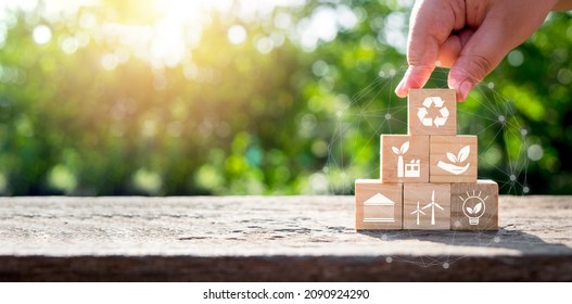 ESG concept of environmental, Man hand holding wooden cube block with ESG icon with copy space, social and corporate governance concept - Shutterstock ID 2090924290