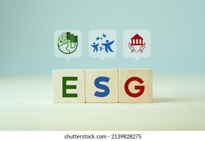 ESG concept of environmental, social and governance. Sustainable corporation development.  Wooden cubes with abbreviation ESG standing with other ESG icons on grey background, copy space. SDGs banner.
