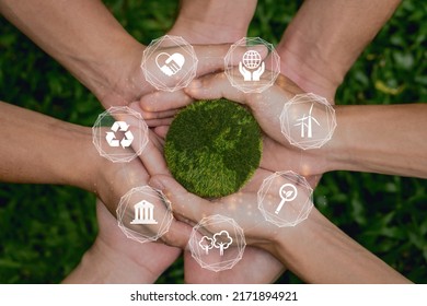 ESG concept of environmental, social and governance.Group of people holding green earth with ESG icon.