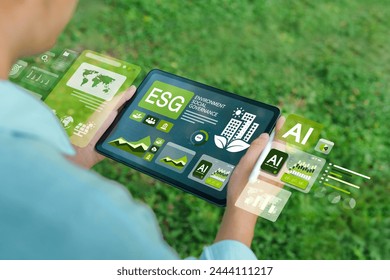 ESG concepts for environment, society and governance. Businessman uses iPad to analyze ESG in business investment strategy concept. which the screen shows with a green graph - Powered by Shutterstock