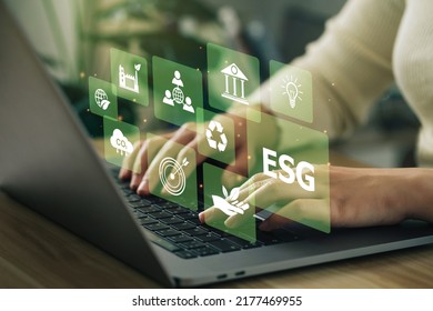 ESG environment social governance investment business concept. Women use a computer to analyze ESG, surrounded by ESG icons .close to the computer screen in business investment strategy concept. - Shutterstock ID 2177469955