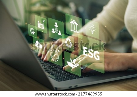 ESG environment social governance investment business concept. Women use a computer to analyze ESG, surrounded by ESG icons .close to the computer screen in business investment strategy concept.