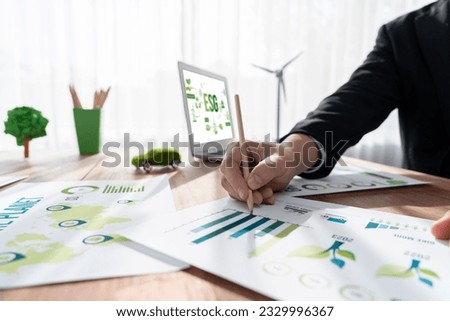 ESG environmental social governance display on laptop on eco-friendly company with businessman planning on environmental protection initiative for clean and sustainable future ecology. Trailblazing