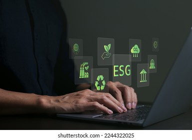 ESG environmental social governance investment business concept. Businessman use a computer to analyze ESG data. icons pop up on virtual screen in business sustainability investment strategy concept. - Shutterstock ID 2244322025
