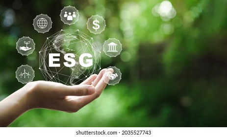 ESG Icon Concept In The Hand For Environmental, Social, And Governance In Sustainable And Ethical Business On The Network Connection On A Green Background.