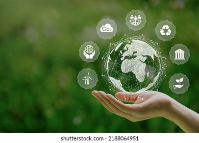 ESG icon concept in the woman hand for environmental, social, and governance by using technology of renewable resources to reduce pollution and carbon emission. - Shutterstock ID 2188064951