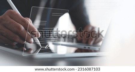 E-signing, electronic signature, document approve, paperless office concept. Businessman using stylus pen signing on e-document on digital tablet with digital business contract on virtual screen