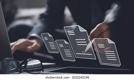 E-signing, electronic signature, document management, paperless office concept. Businessman using stylus pen signing on e document on digital tablet on tablet and virtual notepad on virtual screen