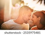 Eskimo kiss, love and couple in nature for bonding, commitment and relax together in morning. Dating, lens flare and happy man and woman embrace for affection, care or support for loving relationship