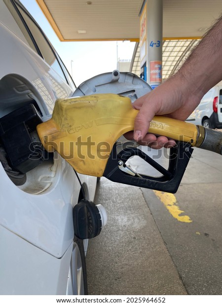 Eskisehir, Turkey- 2021: Man\
filling  fuel to the car at petrol station. Economy and finance\
concept.
