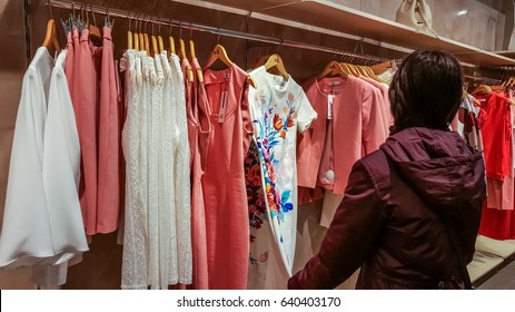 Eskisehir, Turkey - April 18, 2017: Young woman looking at a fashionable dress in a woman clothing shop in Eskisehir - Shutterstock ID 640403170