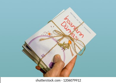 Eskisehir, Turkey - October 09, 2018: Caucasian Man Hand Holding A Book Set Of Antoine De Saint-Exupéry