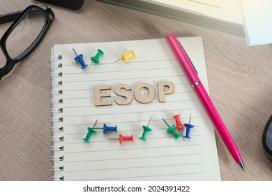 ESOP or Employee Stock Ownership Plan concept.  Selective focus on ESOP letterings on the notebook with pins, pen, and eyeglasses.  
