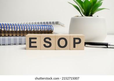 esop sign on the wooden cubes and notepads. Business concept
