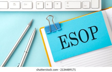 ESOP text on sticker on blue background with pen and keyboard