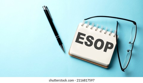 ESOP text written on notepad on the blue background
