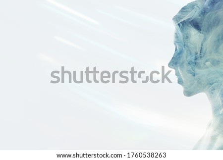 Esoteric portrait. Spiritual enlightenment. Blue mist in peaceful woman silhouette double exposition isolated on white.