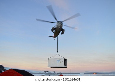 Esperanza Base; Antarctica, Argentina - 03/11/2018. Argentinian sea king helicopter downloading a container to the base. Extreme Logistics