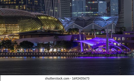 The Esplanade Theatres on the Bay in Singapore at dusk, with beautiful reflection in water night view. Illuminated tent with people