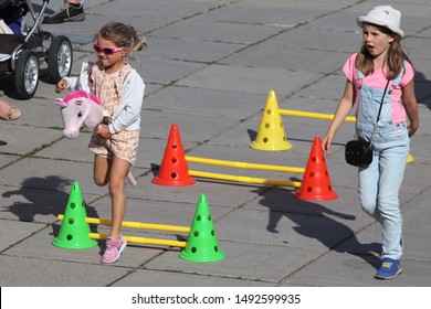 ESPOO, FINLAND - AUGUST 31 2019. In the annual urban festival Espoo day, one of the activities for the children was to ride a hobby horse through a jumping course. 