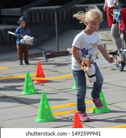 ESPOO, FINLAND - AUGUST 31 2019. In the annual urban festival Espoo day, one of the activities for the children was to ride a hobby horse through a jumping course.