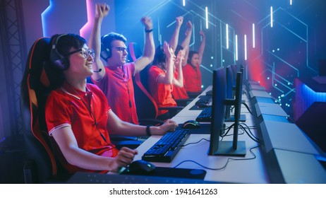 Esport Team Of Pro Gamers Play In Video Game On A Championship Arena, Happy Team Wins Round Celebrates With High-Fives. Cyber Games Online Broadcasting Tournament Event.