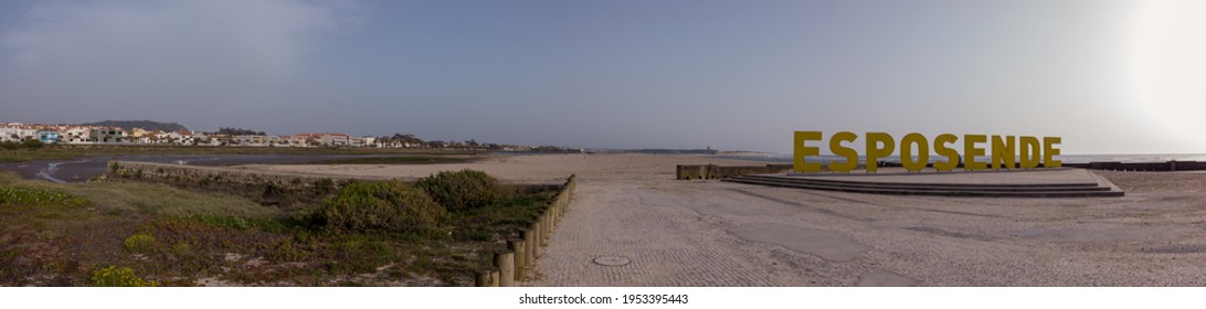 Esposende, Portugal - April 3, 2021: Panoramic Shot Of The Big Yellow Block Letters Spelling Esposende Offer Tourists A Selfie-photo Opportunity With A Beautiful Blue Sea In The Background.