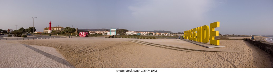 Esposende, Portugal - April 3, 2021: Panoramic Shot Of The Big Yellow Block Letters Spelling Esposende Offer Tourists A Selfie-photo Opportunity With A Beautiful Blue Sea In The Background.