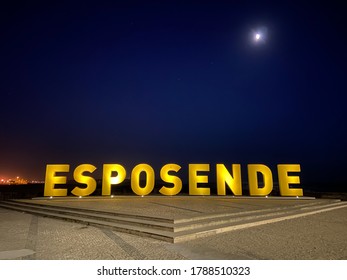 Esposende / Portugal - July 28, 2020: Big Yellow Block Letters Spelling Esposende Offer Tourists A Selfie-photo Opportunity With A Beautiful Blue Sea In The Background.