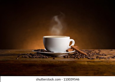 espresso with cinnamon sticks on wooden table