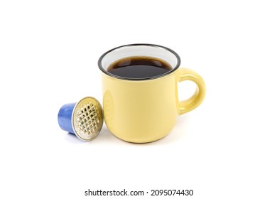 An Espresso Coffee Cup With A Used Coffee Pod Isolated On White