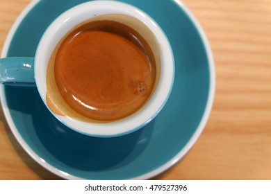 Espresso Coffee Drink in blue Mug on wooden table - Powered by Shutterstock