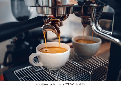 Espresso coffee extraction from a professional coffee machine with a bottomless filter, Close-up of a coffee drop  from the coffee machine - Powered by Shutterstock