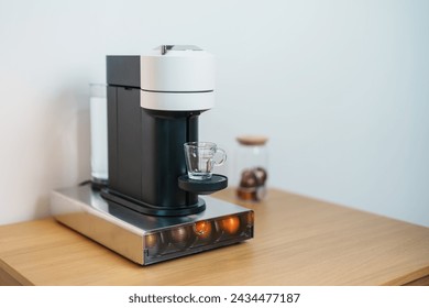 Espresso Coffee Maker Machine with Capsule of roasted coffee bean on wood table bar. Daily beverage drink at Home, Apartment and Office concept