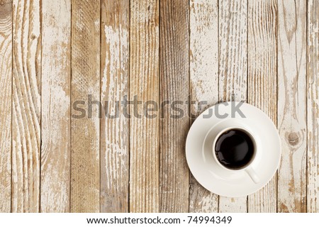 espresso coffee in a white china cup over grange wood surface with paint peeling off