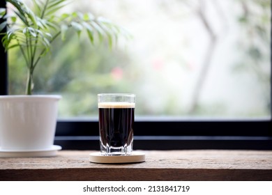 Espresso In A Glass Cup And Small Bamboo Palm Plant Pot