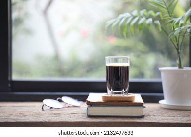 Espresso In A Glass Cup And Small Bamboo Palm Plant Pot And Glasses