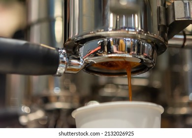 espresso machine pouring espresso coffee - Shutterstock ID 2132026925