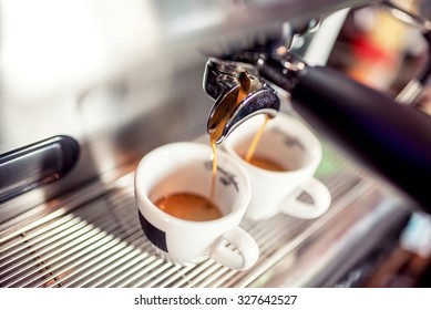 Espresso machine pouring fresh coffee into cups at restaurant. Coffee automatic machine making coffee