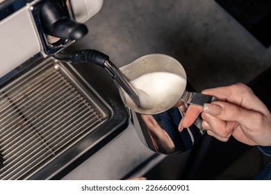 Espresso machine pours fresh black coffee closeup. Coffee machine preparing fresh coffee and pouring into yellow cups at restaurant, bar or pub. - Powered by Shutterstock