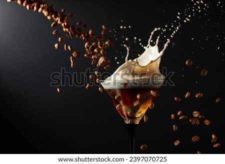 Espresso Martini drink with splashes and falling coffee beans on a black background. Copy space.