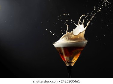 Espresso Martini drink with splashes on a black background. Copy space.