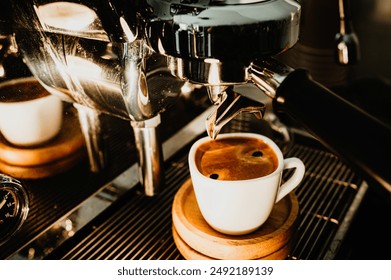 Espresso pouring from coffee machine at cafe,Brewing the espresso coffee from the machine warm tone. - Powered by Shutterstock