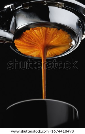 Espresso shot from espresso machine dark background