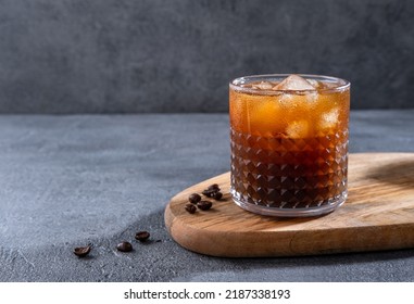 Espresso Tonic, cold drink with espresso and tonic in glass. Ice coffee in a tall glass with cream poured over and coffee beans. Set with different types of coffee drinks on a dark table. - Shutterstock ID 2187338193