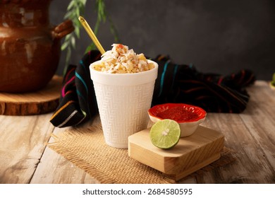 Esquites. Corn kernels cooked and served with mayo, sour cream, lemon and chili powder, very popular street food in Mexico, also known as Elote en Vaso. The recipe varies depending on the region.