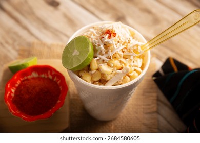 Esquites. Corn kernels cooked and served with mayo, sour cream, lemon and chili powder, very popular street food in Mexico, also known as Elote en Vaso. The recipe varies depending on the region.