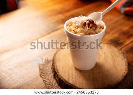 Esquites. Corn kernels cooked and served with mayo, sour cream, lemon and chili powder, very popular street food in Mexico, also known as Elote en Vaso. The recipe varies depending on the region.